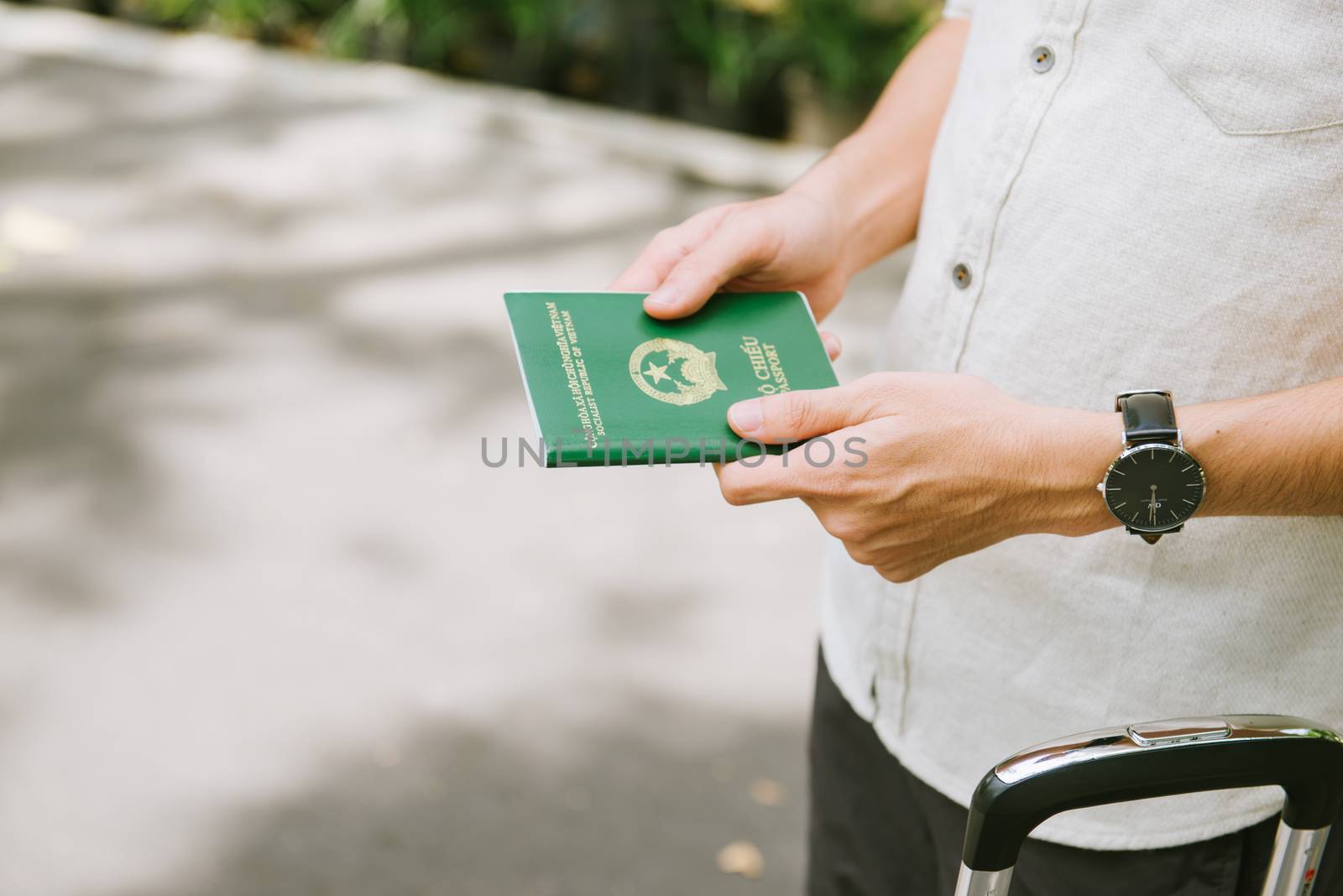 Man hands holding Vietnamese Passport. Ready for traveling. by makidotvn