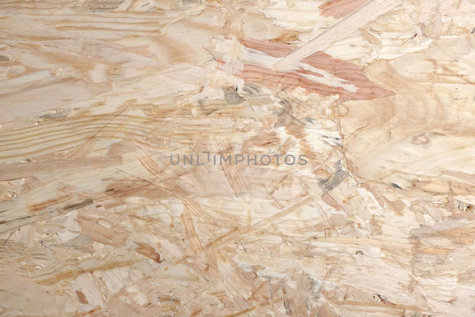 Smooth pale background of OSB - oriented strand board - wooden strips combined with adhesive to make sheet building material.