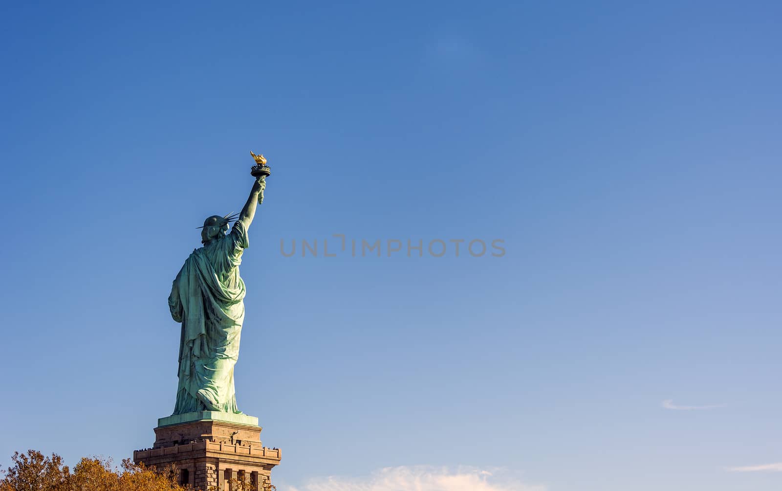 Back of the most famous Statue of Liberty in NY city, USA on a clear blue day