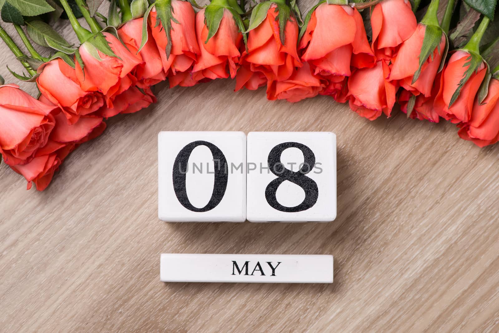Cube shape calendar for MAY 08 on wooden table with roses by makidotvn