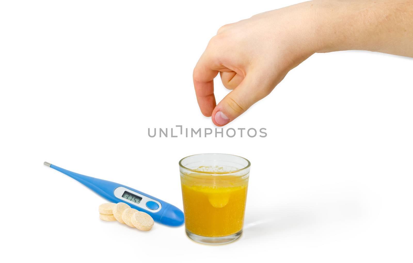 Effervescent medicinal tablet thrown into the glass of water by human hand, several same tablets separately beside and blue electronic clinical thermometer on a light background
