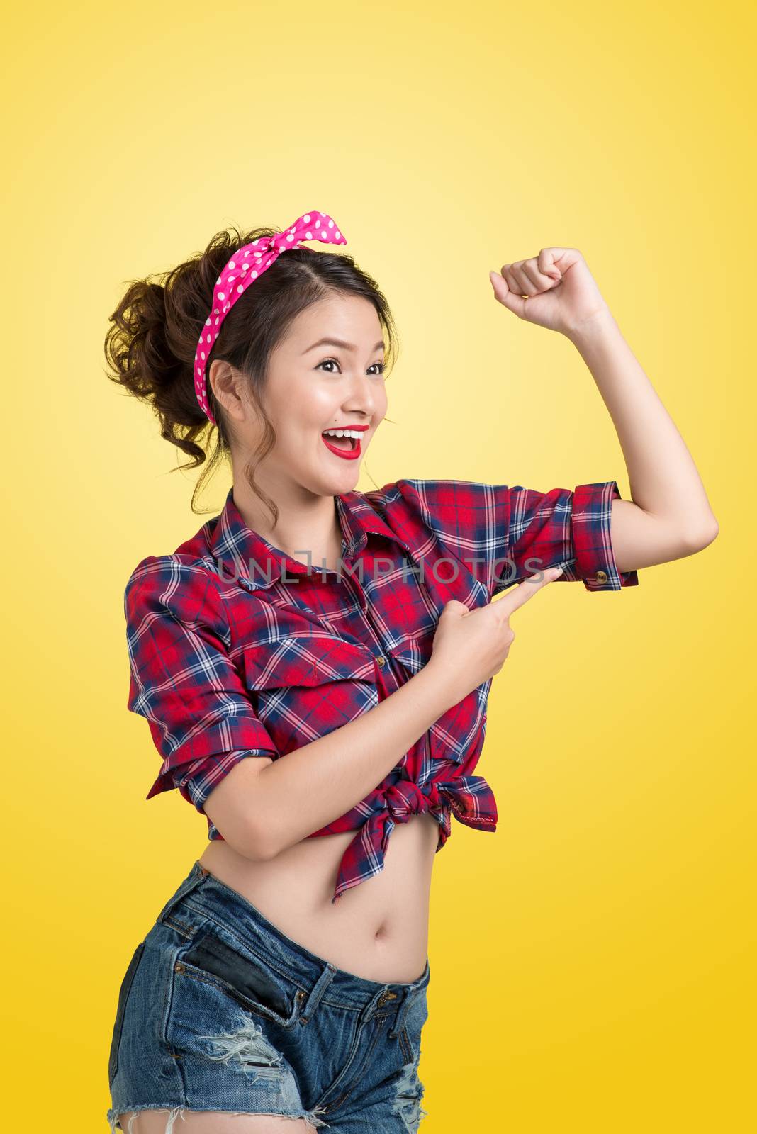 Young pin-up woman like classic We Can Do It poster over yellow  by makidotvn