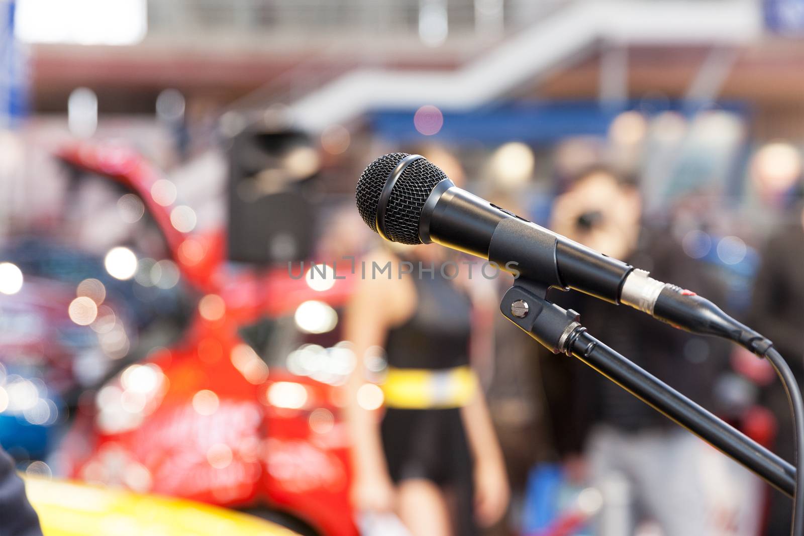 Microphone in focus, against blurred background. Presentation. by wellphoto