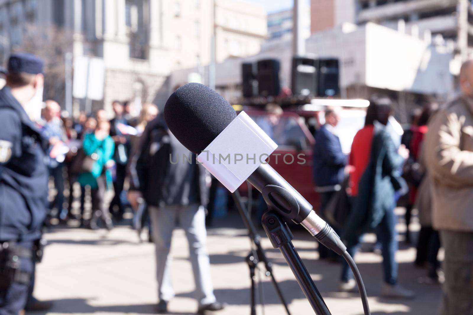 Microphone in focus, blurred crowd in background