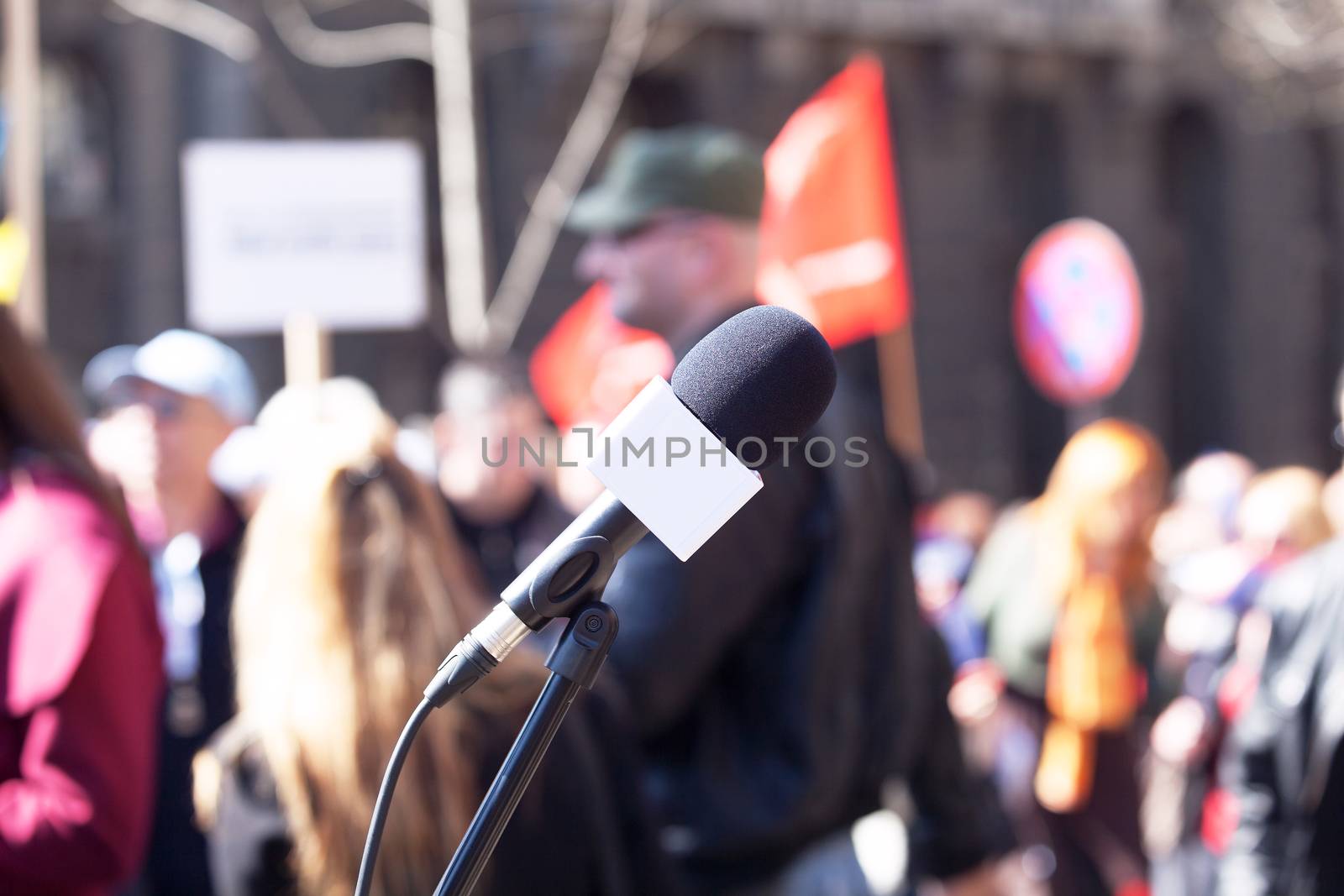 Microphone in focus, blurred crowd in background