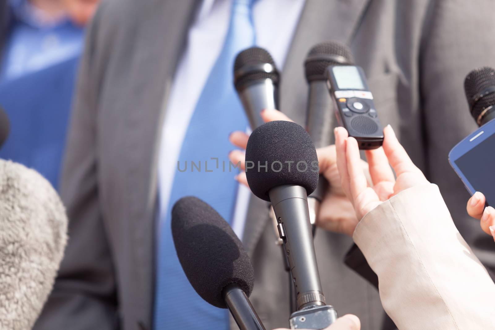 Journalists making media interview with businessperson or politi by wellphoto