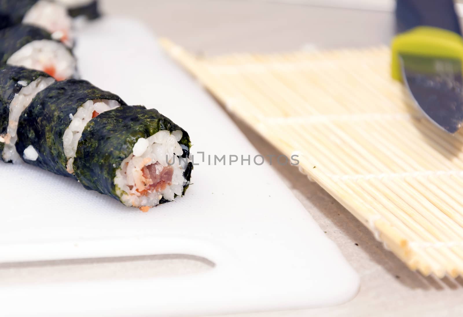 homemade sushi rolls on a white cutboards