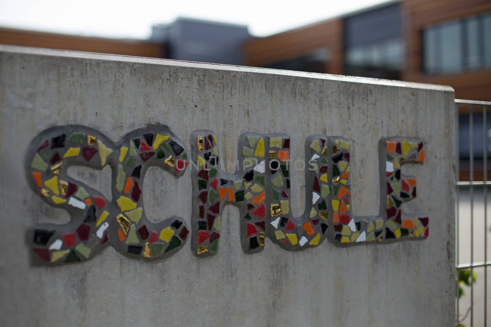 German school sign on a wall of concrete