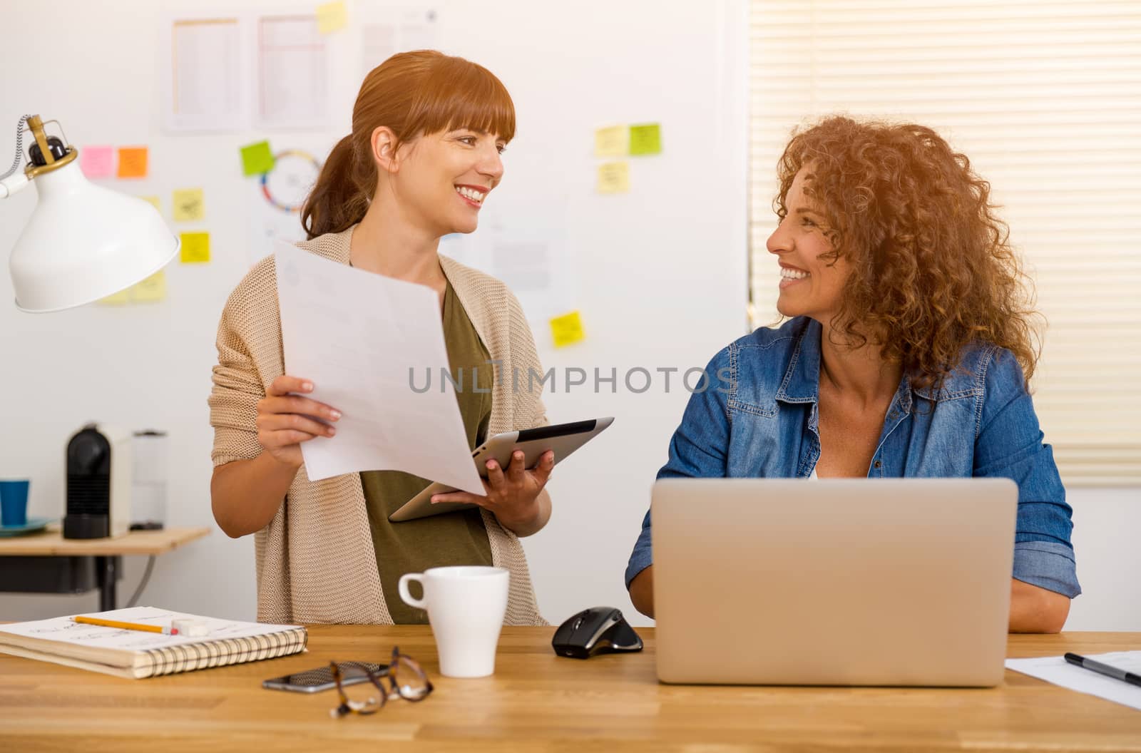 Shot of two businesswoman working together in an office