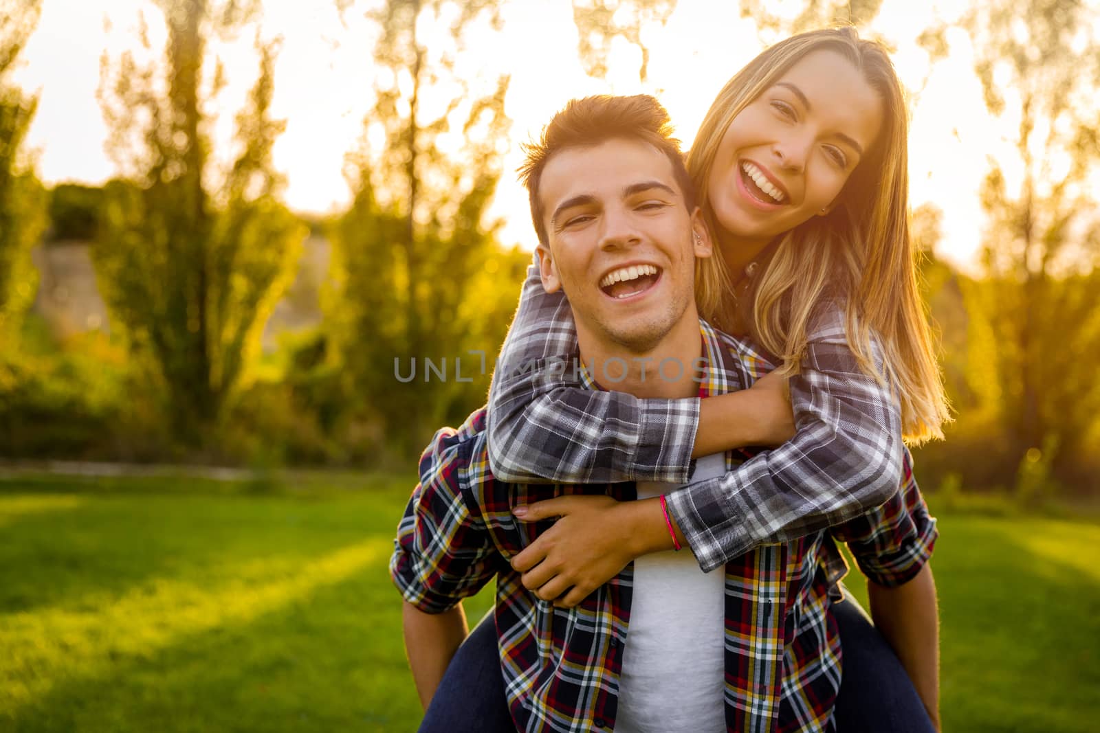 Portrait of a happy young couple in the nature hugged together