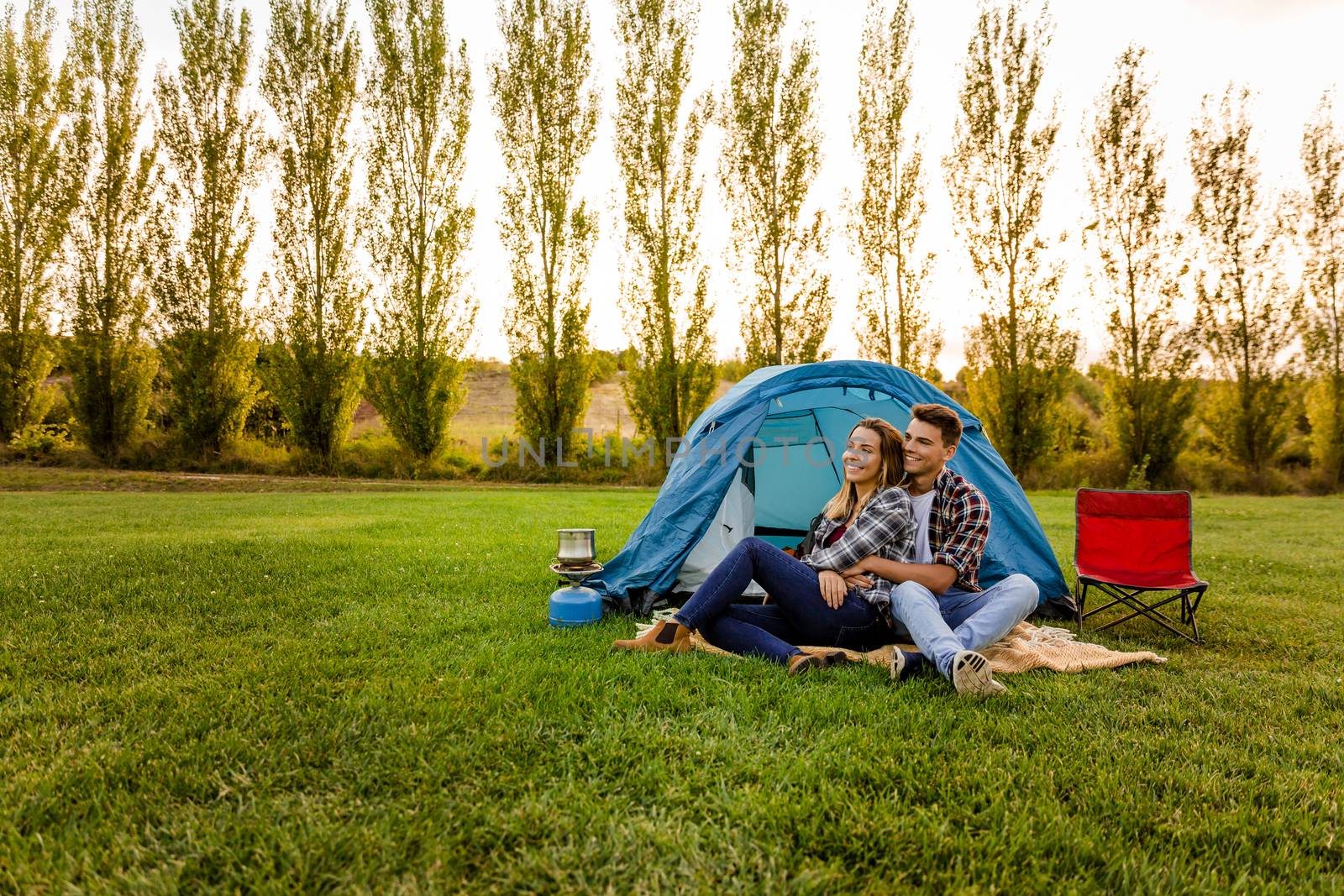 Shot of a happy couple camping on the nature 