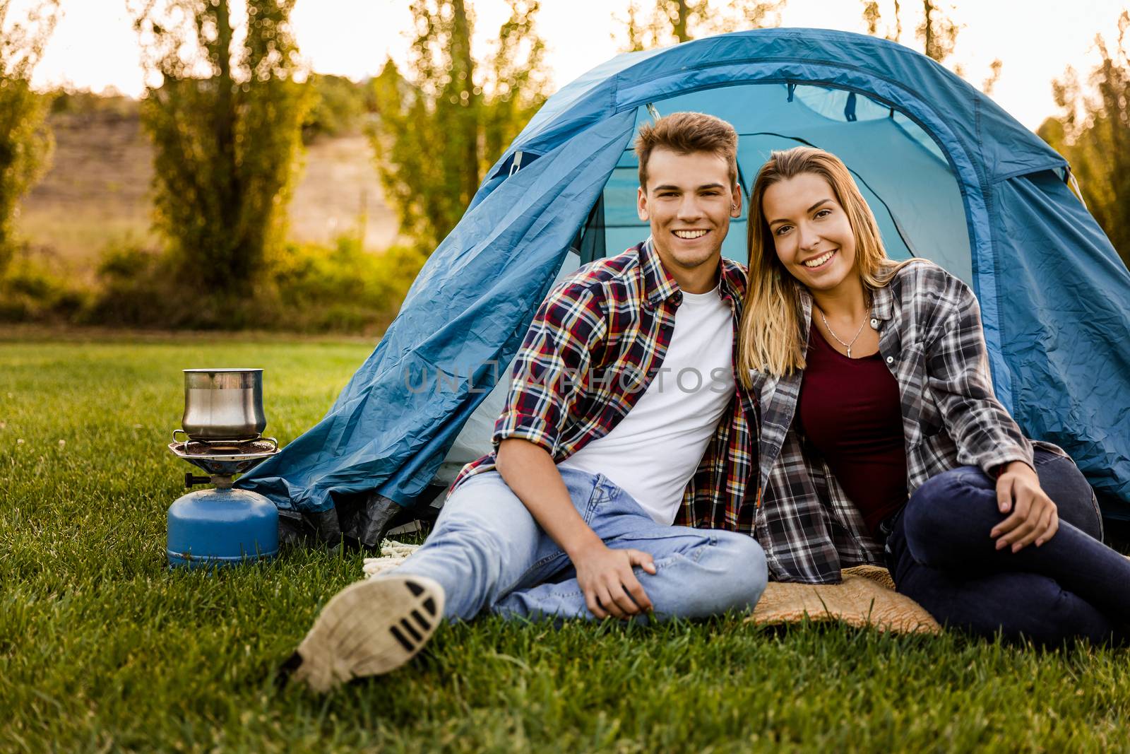 Shot of a happy couple camping on the nature 