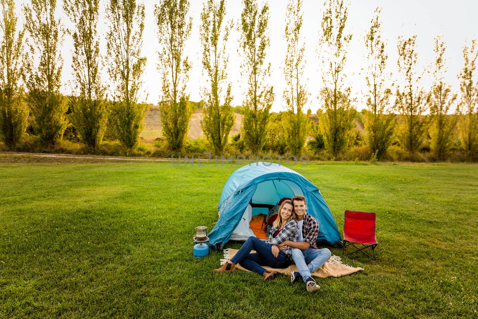 Shot of a happy couple camping on the nature 