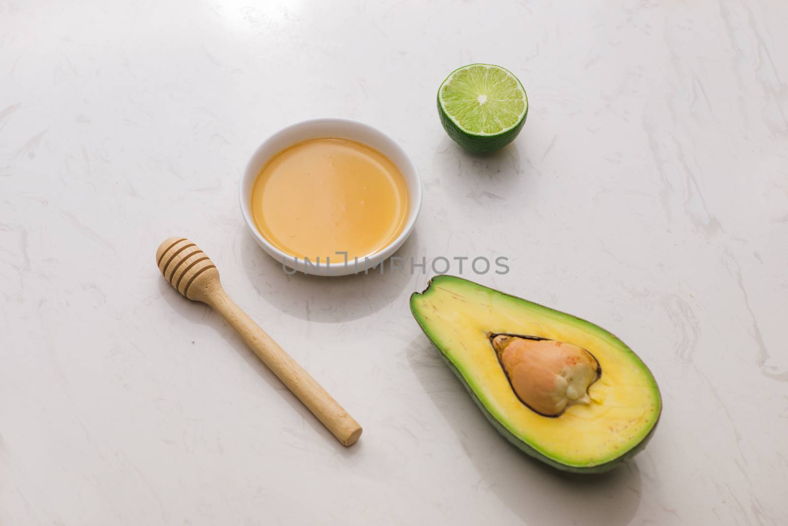 Healthy food concept. Fresh organic avocado with honey on table