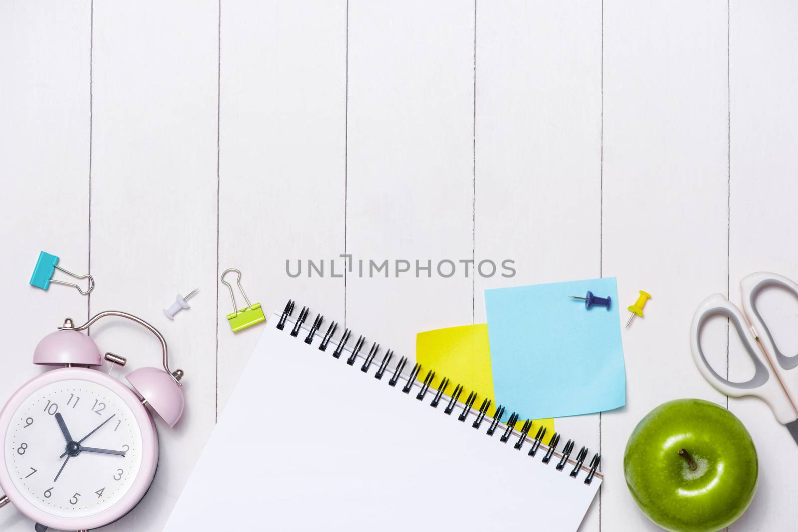 School stationery or office supplies on wood background.