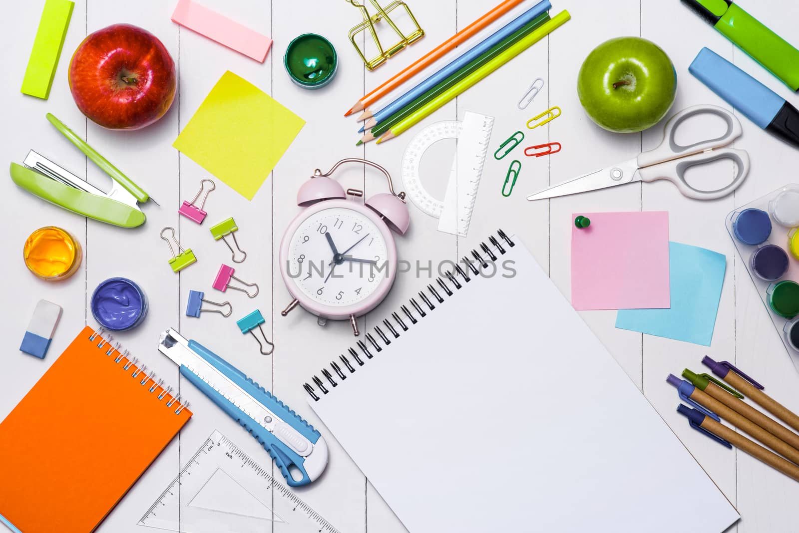 School stationery or office supplies on wood background.