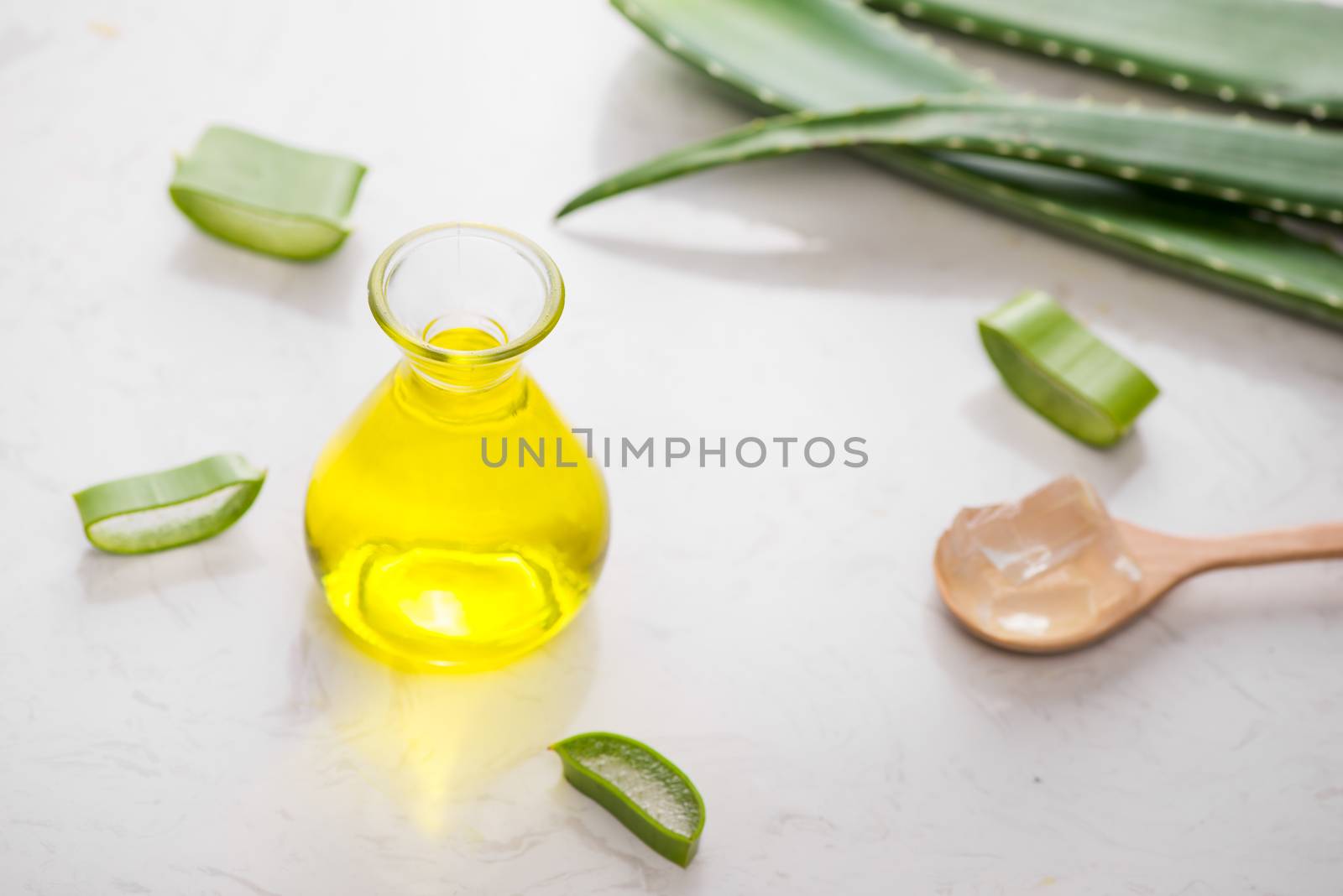 Aloe vera essential oil and aloe leaves on a white background. by makidotvn