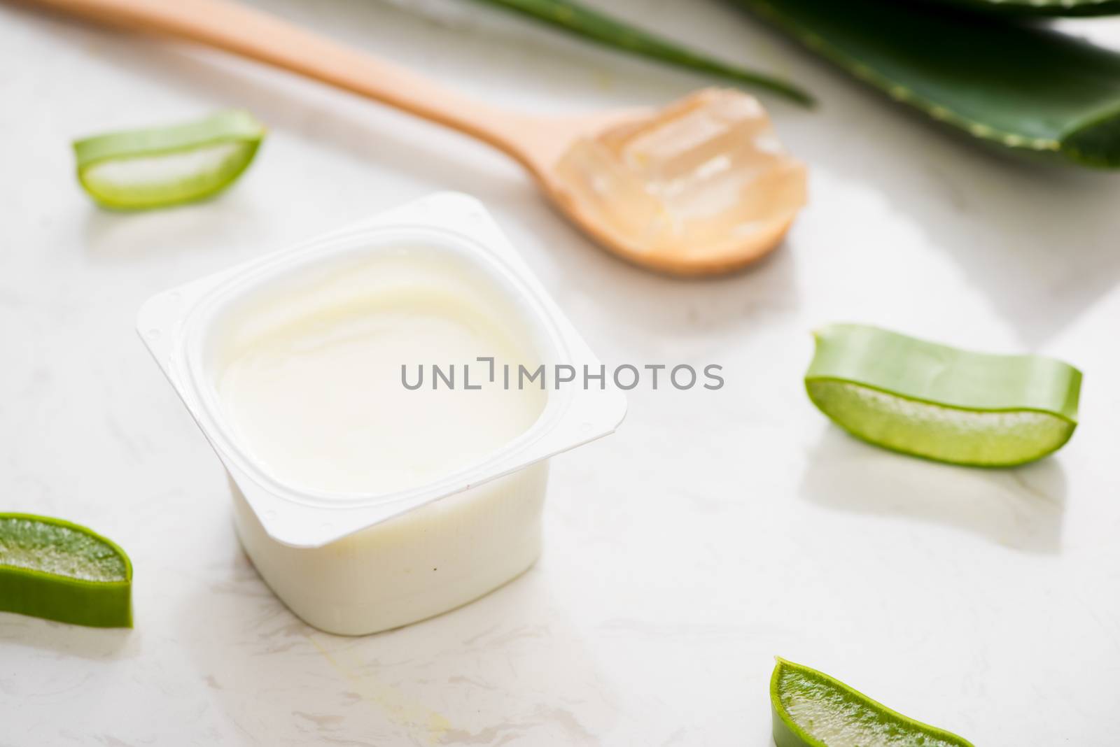 Aloe vera yogurt with fresh leaves on a wooden table by makidotvn