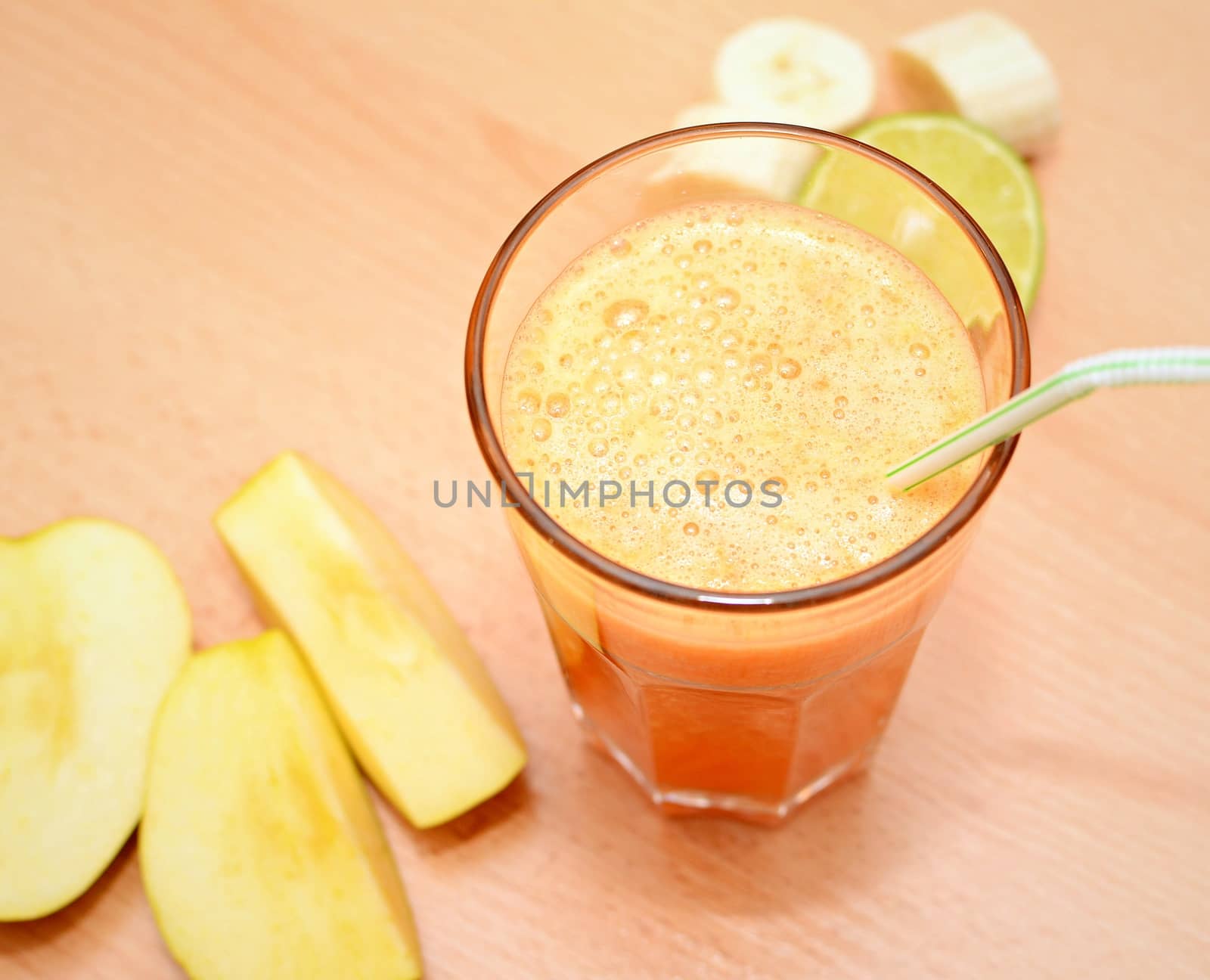 Top Down View of Common Fruit Fresh Smoothie in a Glass on a Wooden Table.