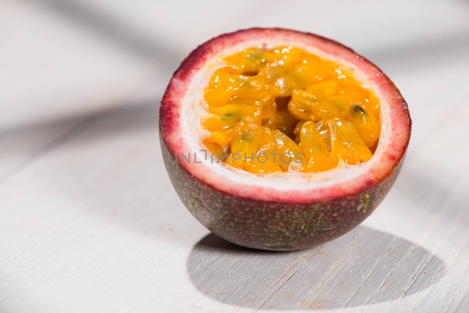 Half of passion fruit on wooden table.