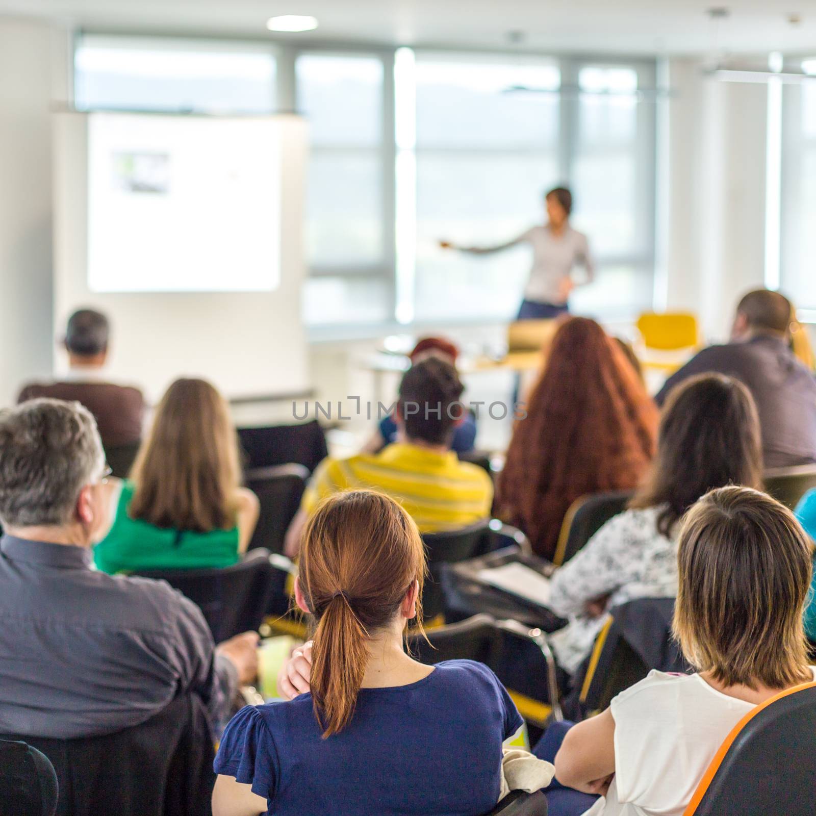 Woman giving presentation on business conference. by kasto