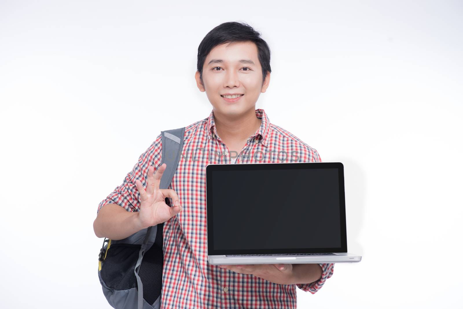 Portrait of young asian student holding and showing screen lapto by makidotvn