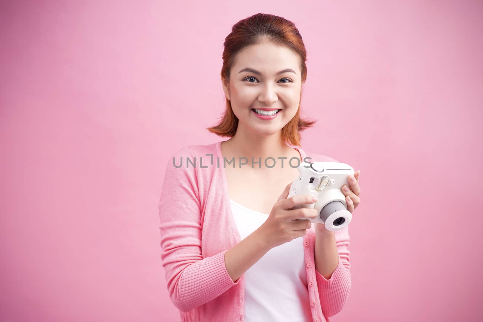 Young woman taking a photo with a camera.