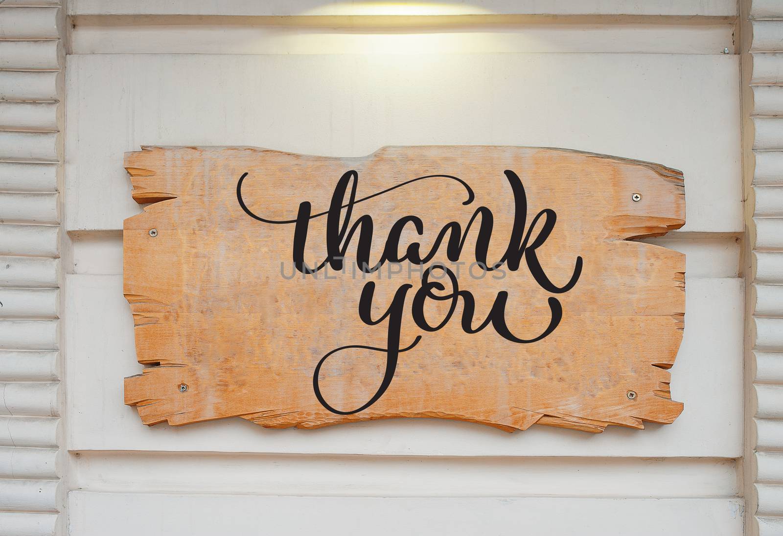 Blank wood board on wall and text Thank you. Calligraphy lettering hand draw by timonko