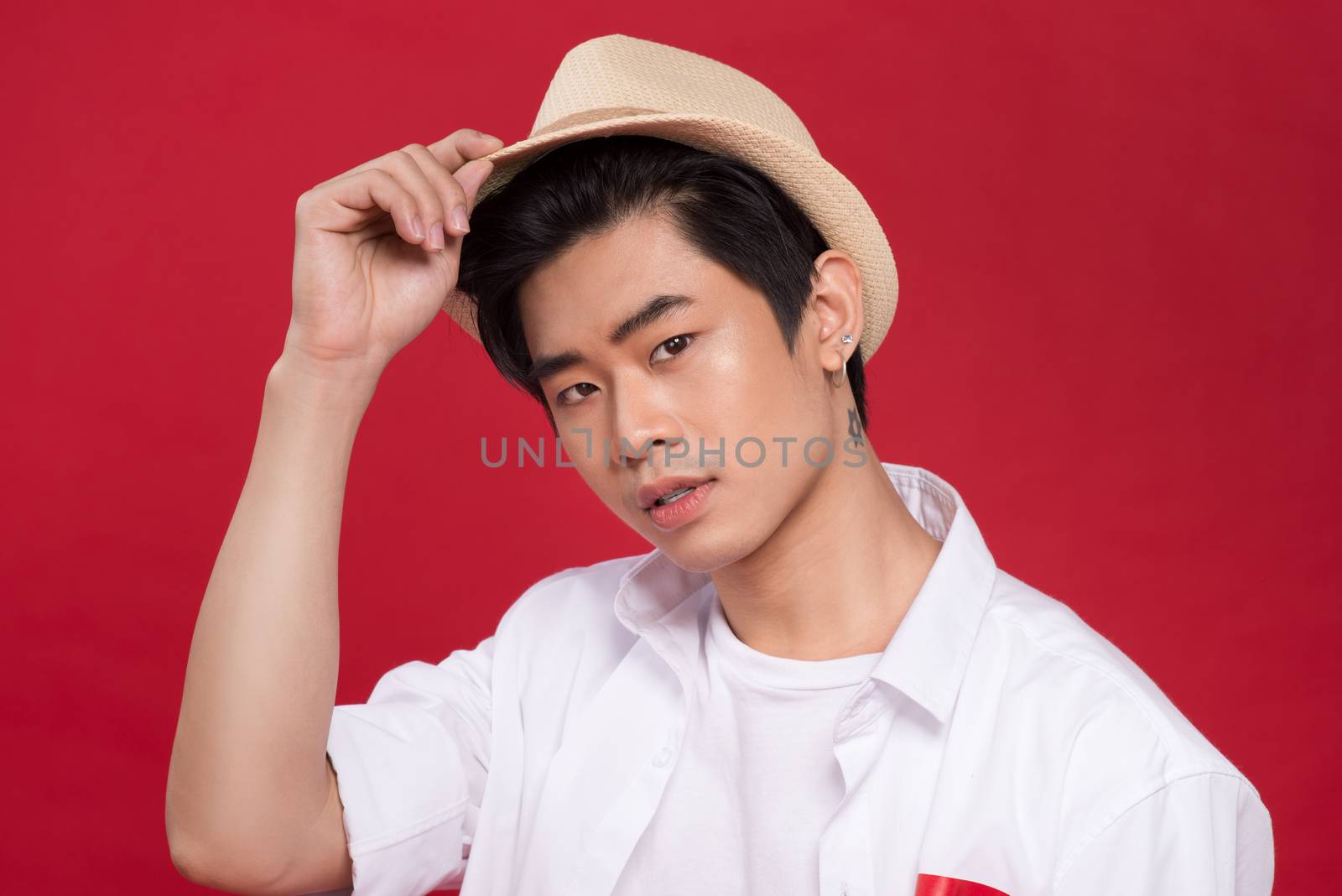 Portrait of elegant young handsome asian man with hat. Cool fash by makidotvn