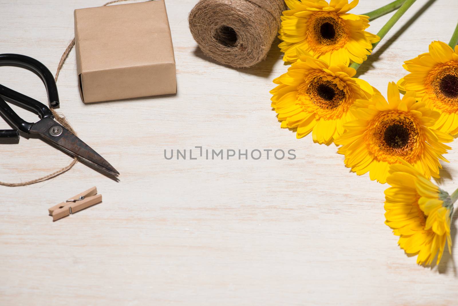 Wrapping flowers gift over wooden background. Top view with copy by makidotvn