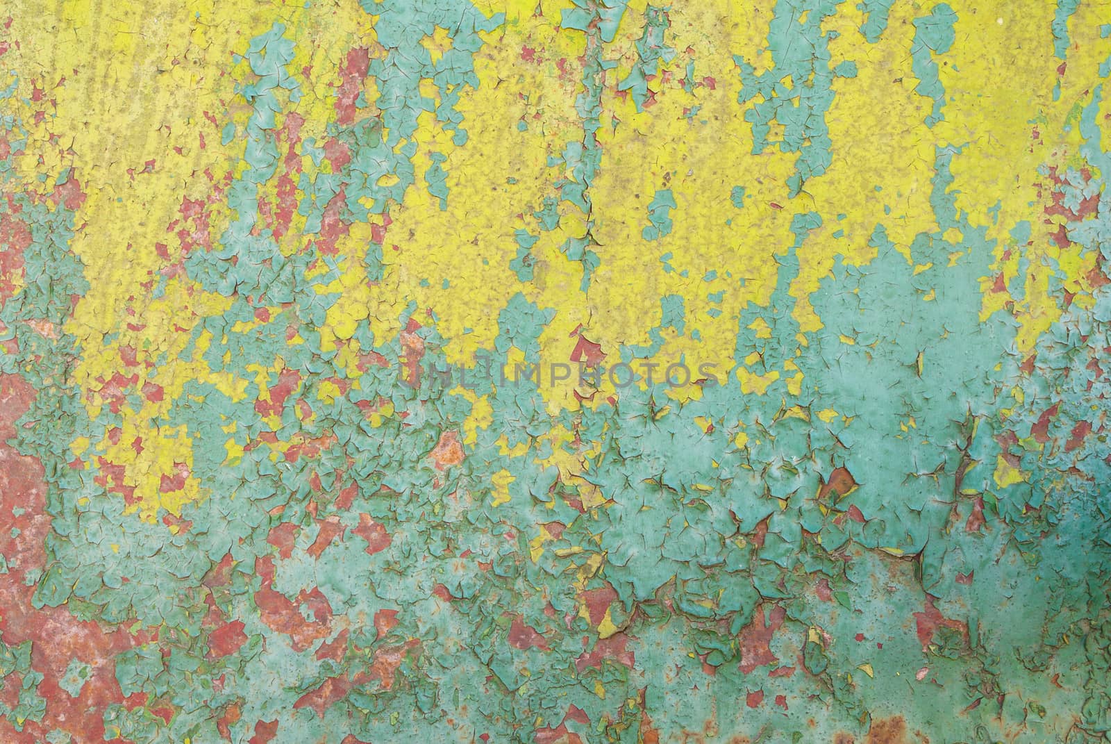 fragment of a rusty iron surface covered with old paint, which has long been under the influence of different climatic conditions