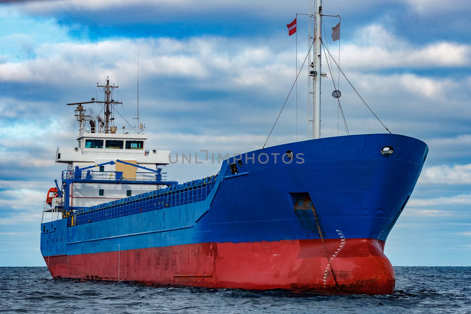 Blue cargo ship moored by sengnsp