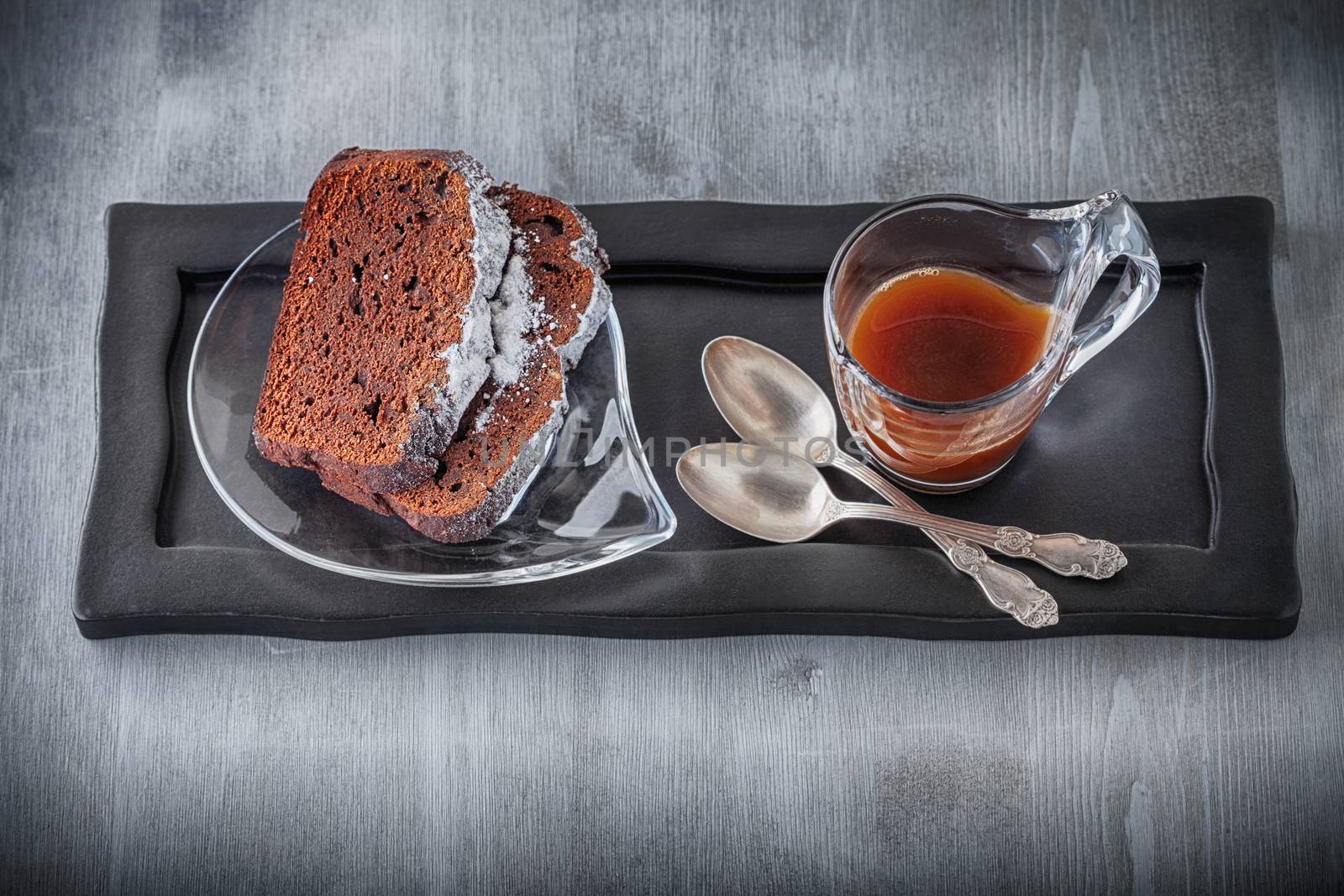 Chocolate cake and coffee on a stone plate