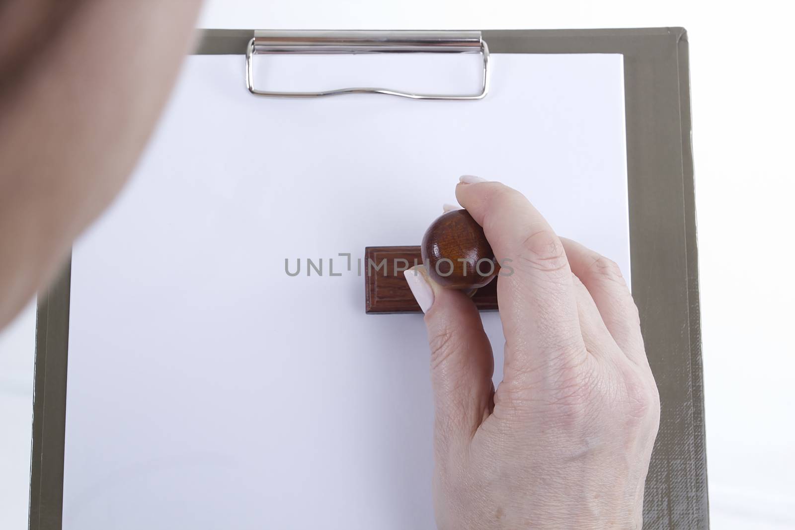 Hands with sheet of paper on clipboard by VIPDesignUSA