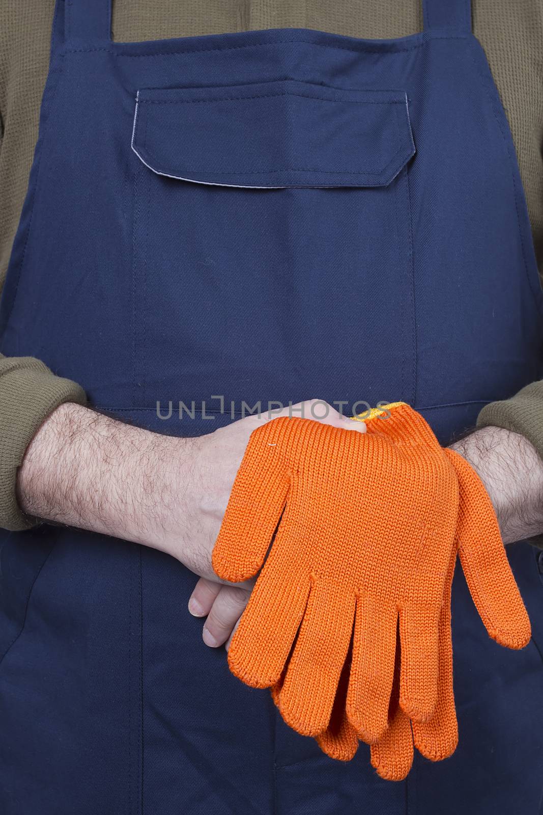 Man in working clothes with gloves. Isolated on a white background.