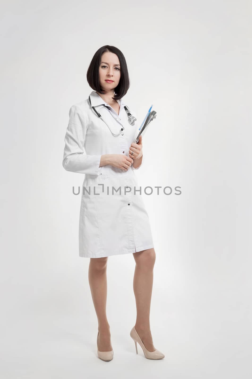 the young beautiful woman the doctor on a white background