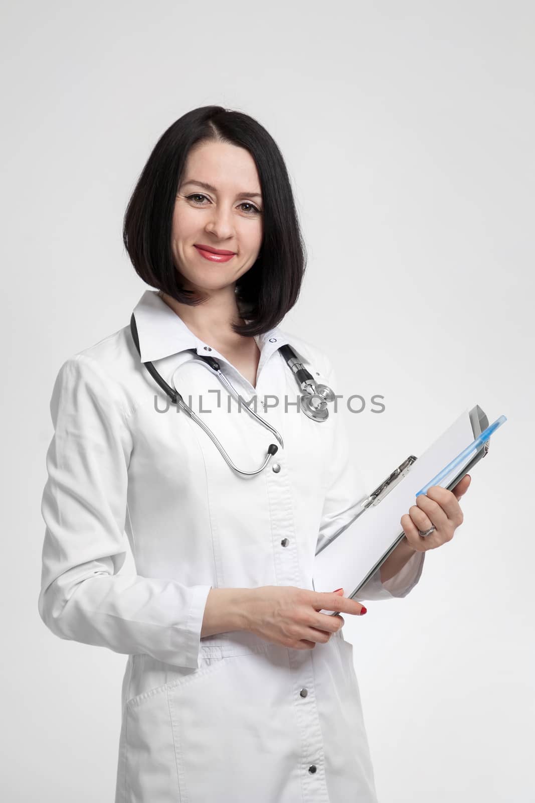 the young beautiful woman the doctor on a white background