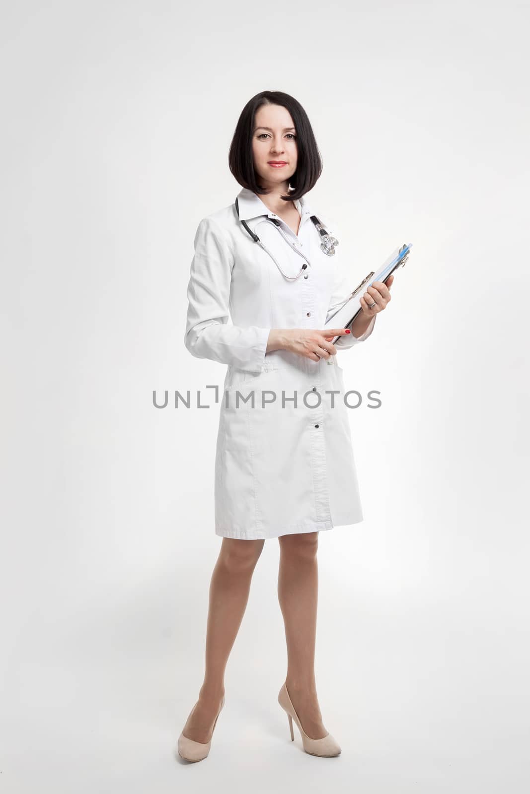 the young beautiful woman the doctor on a white background