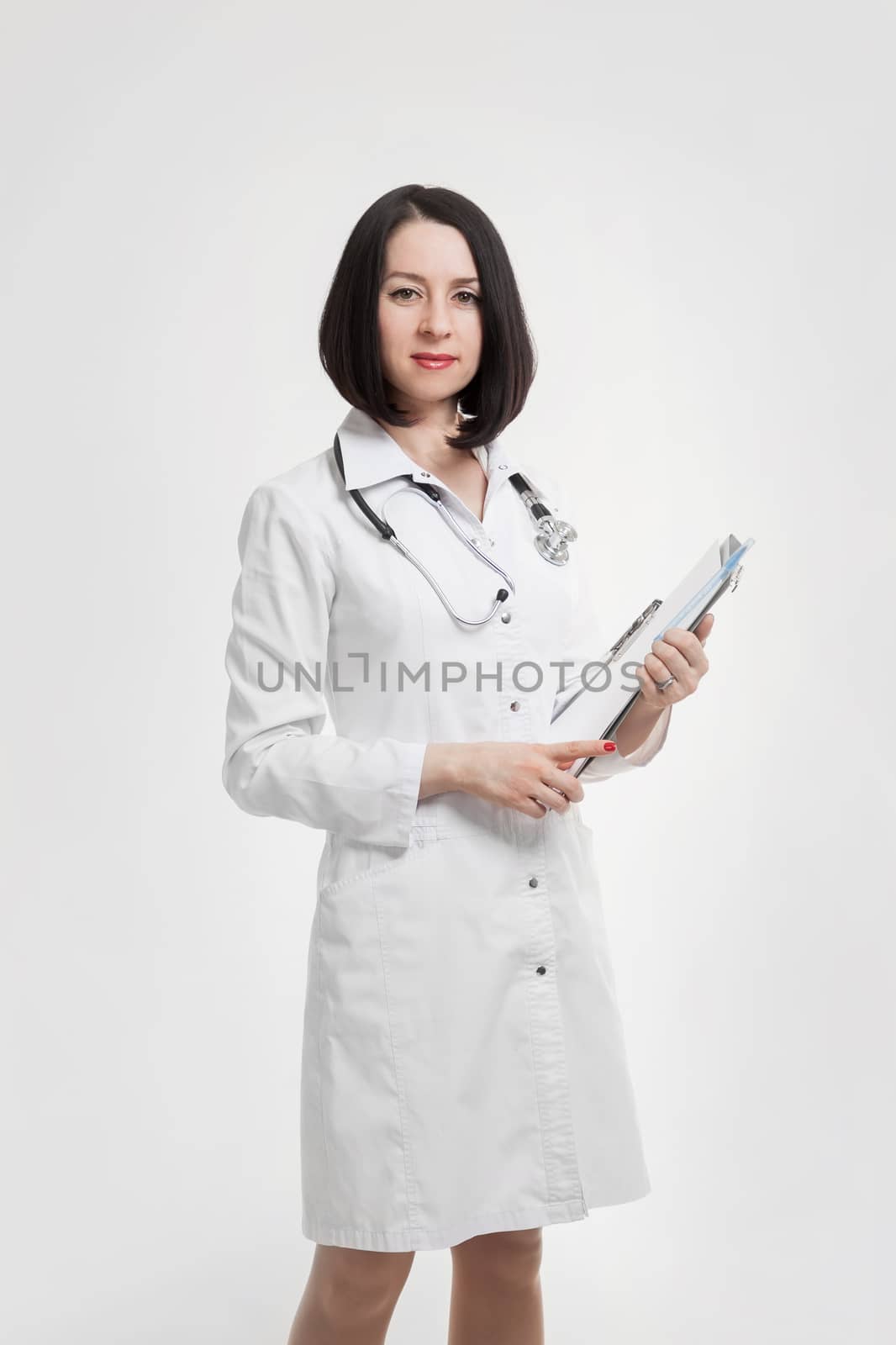 the young beautiful woman the doctor on a white background