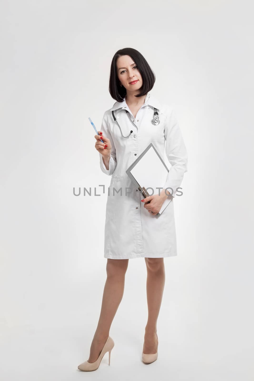 the young beautiful woman the doctor on a white background