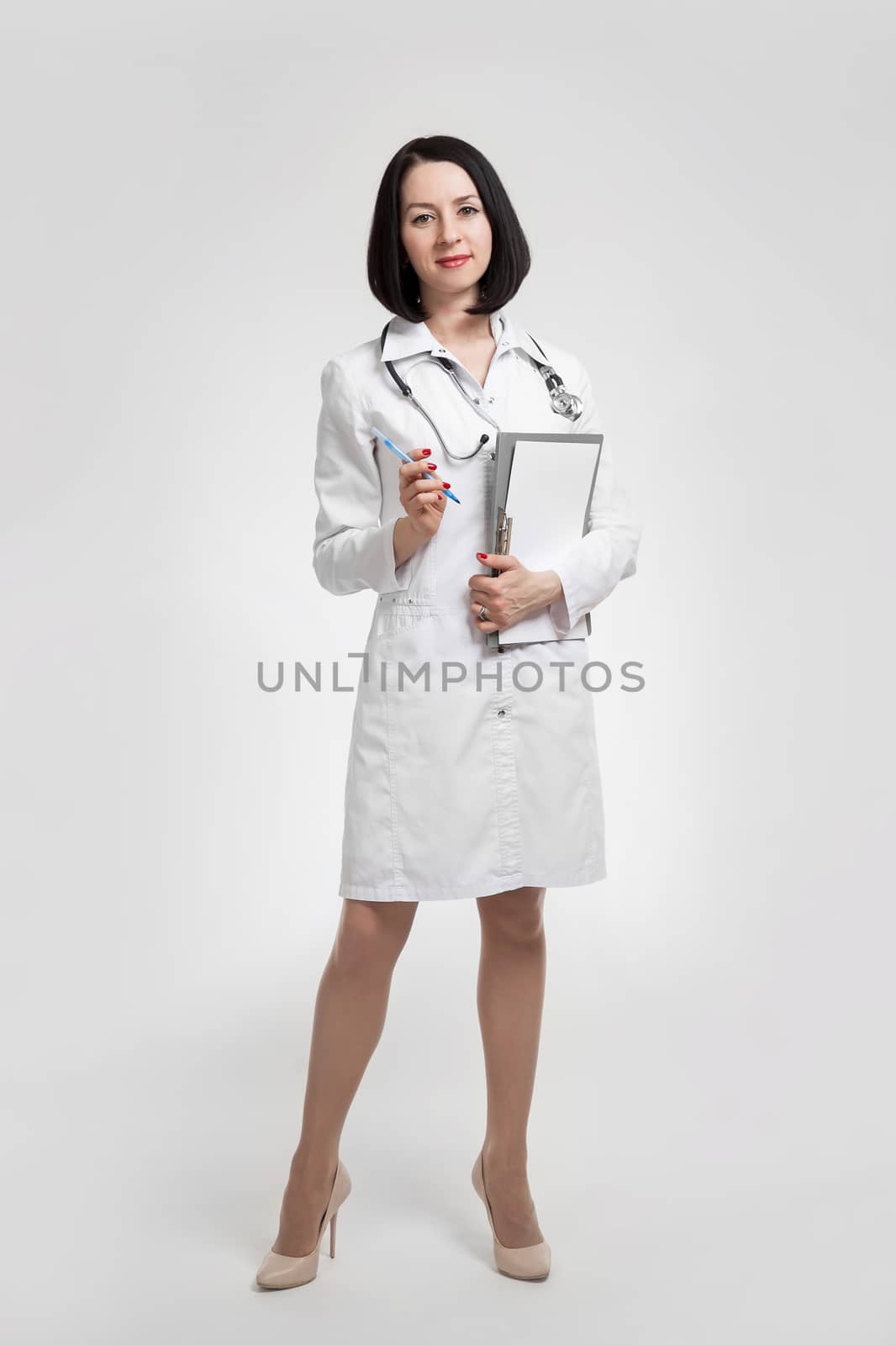 the young beautiful woman the doctor on a white background