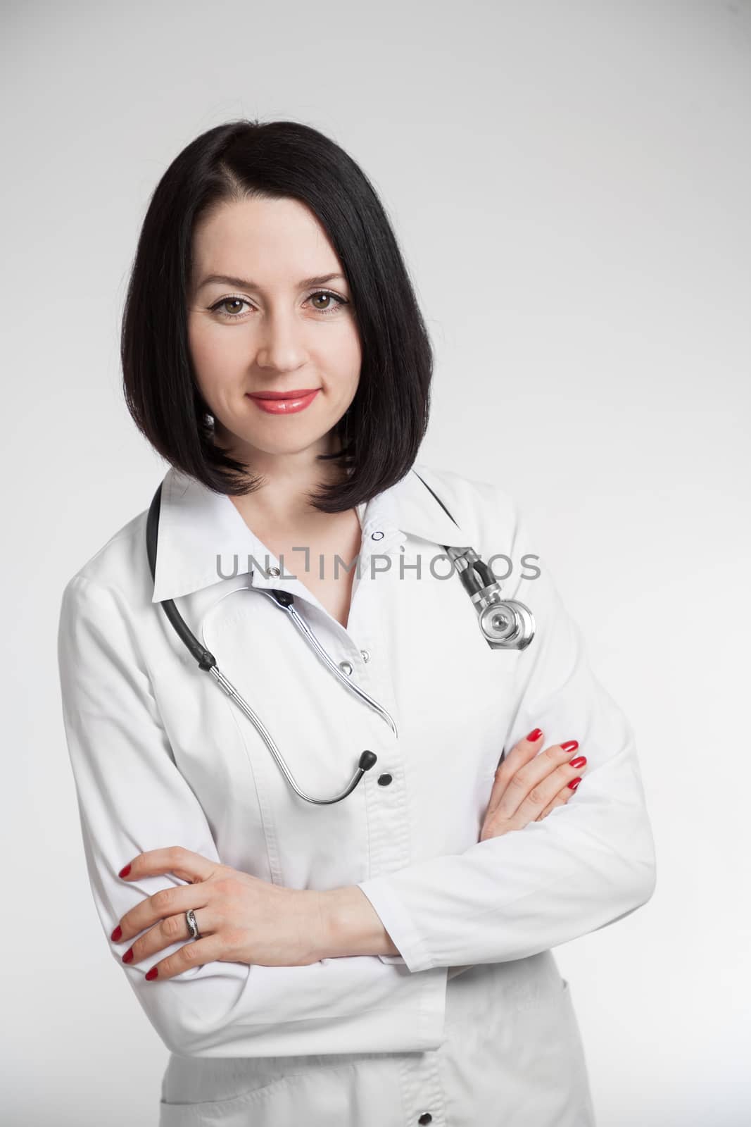 the young beautiful woman the doctor on a white background