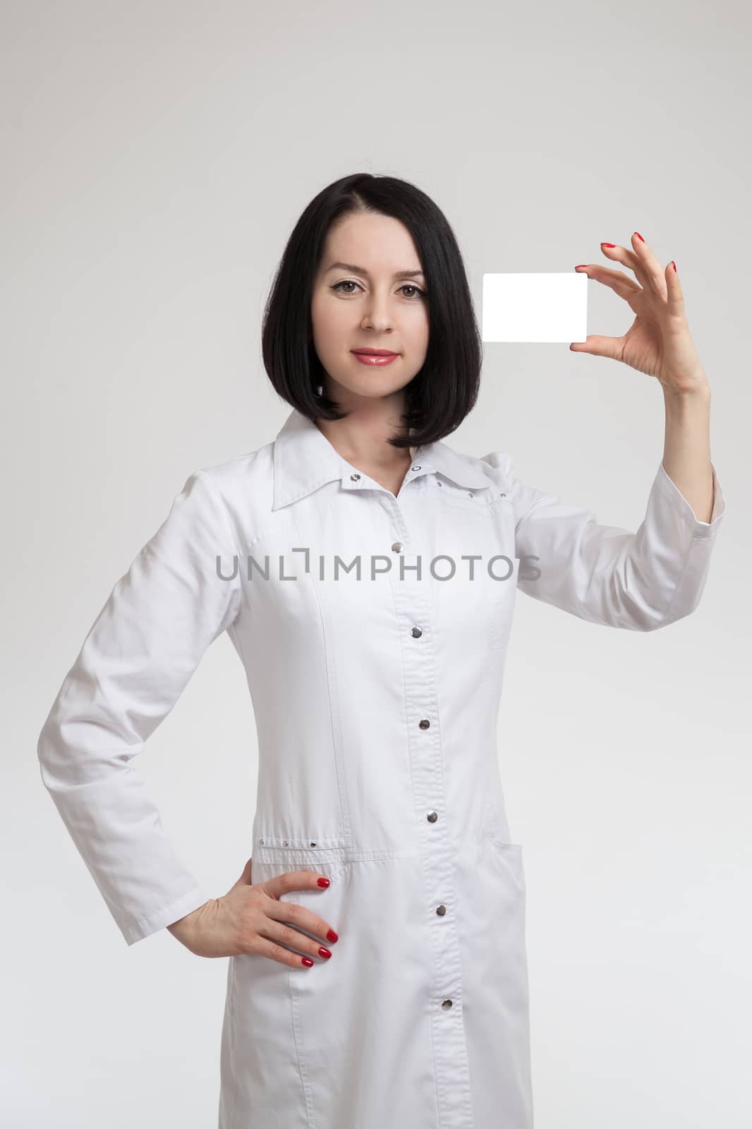 the young beautiful woman the doctor on a white background