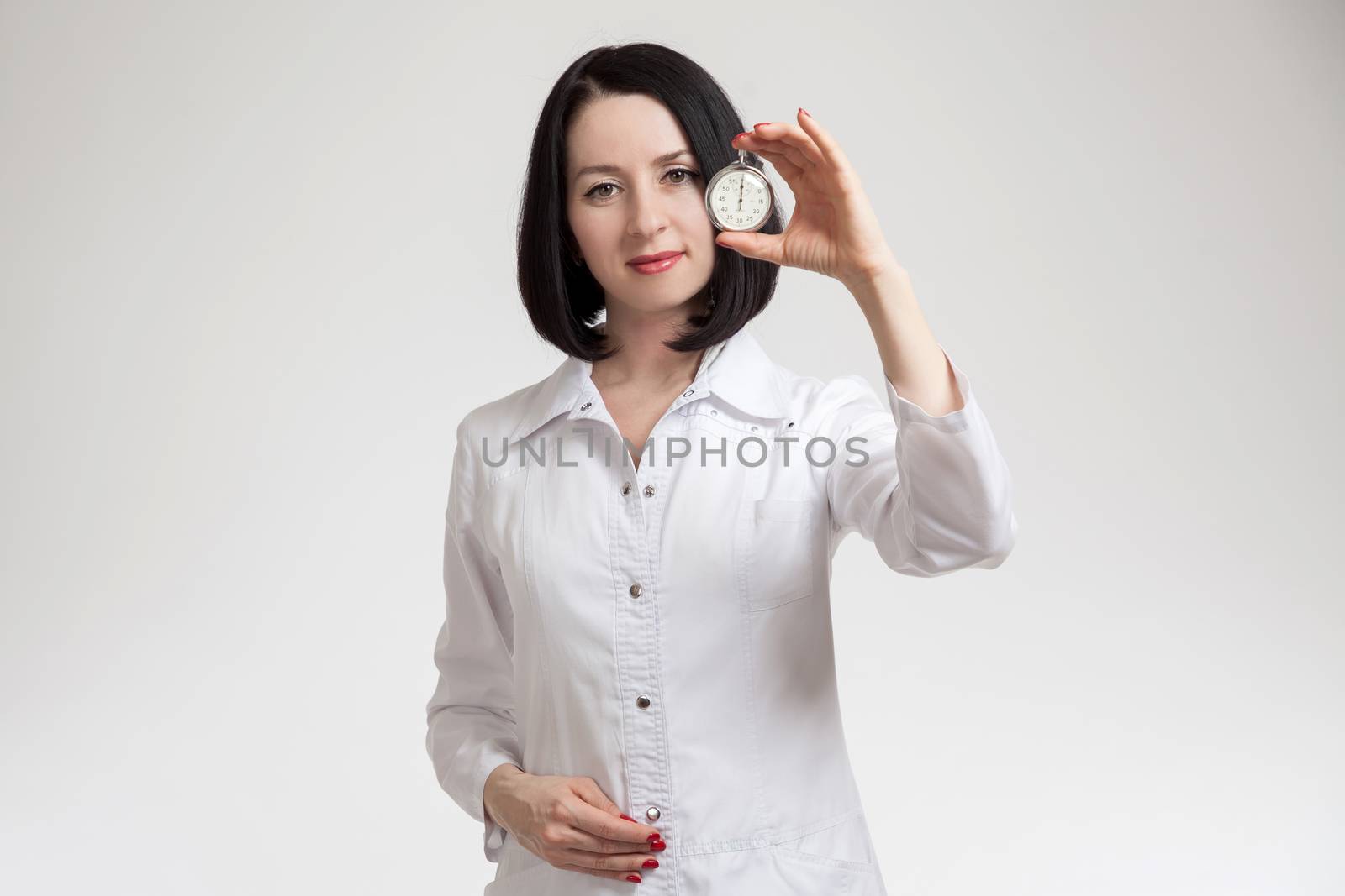 the beautiful woman the doctor with a stop watch on a white background