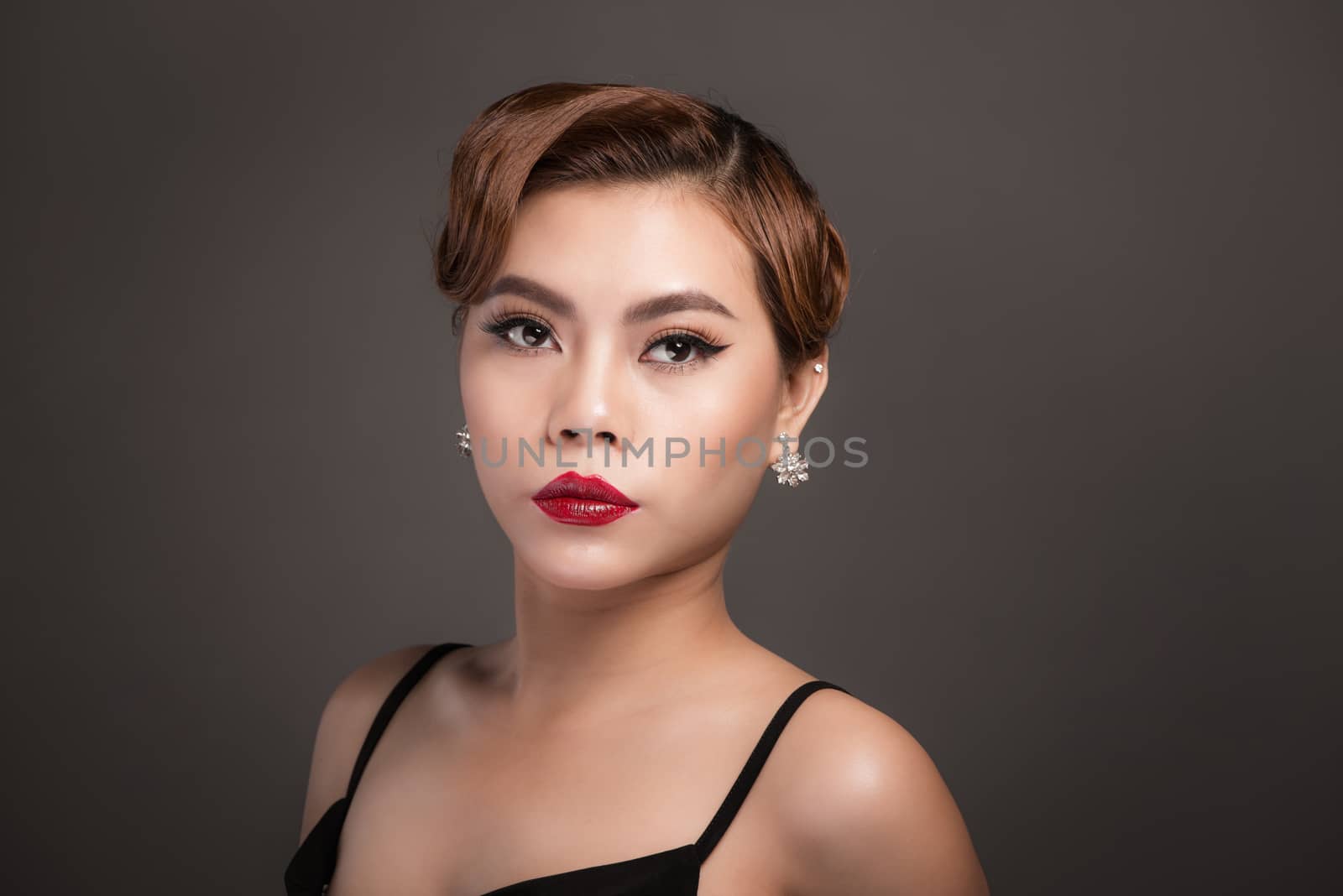 Portrait of beautiful sensual asian woman with elegant hairstyle and perfect makeup. 