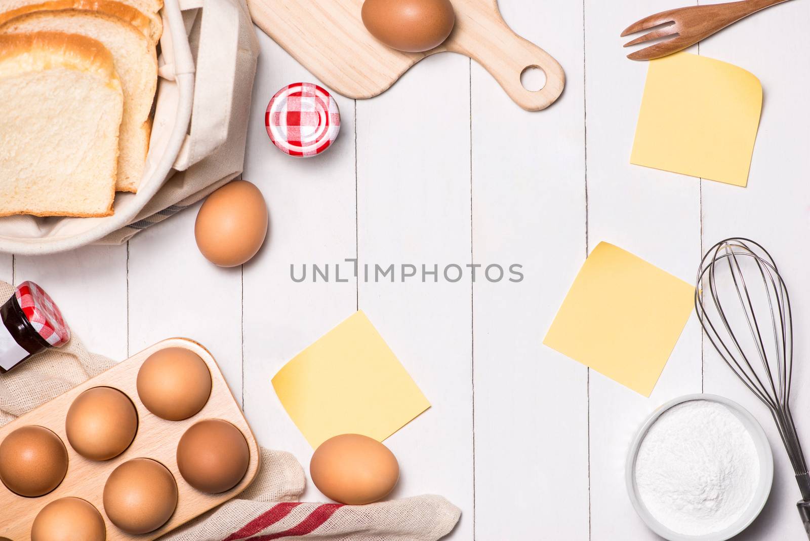 Eggs, milk and bread on white wooden background. Copy-space