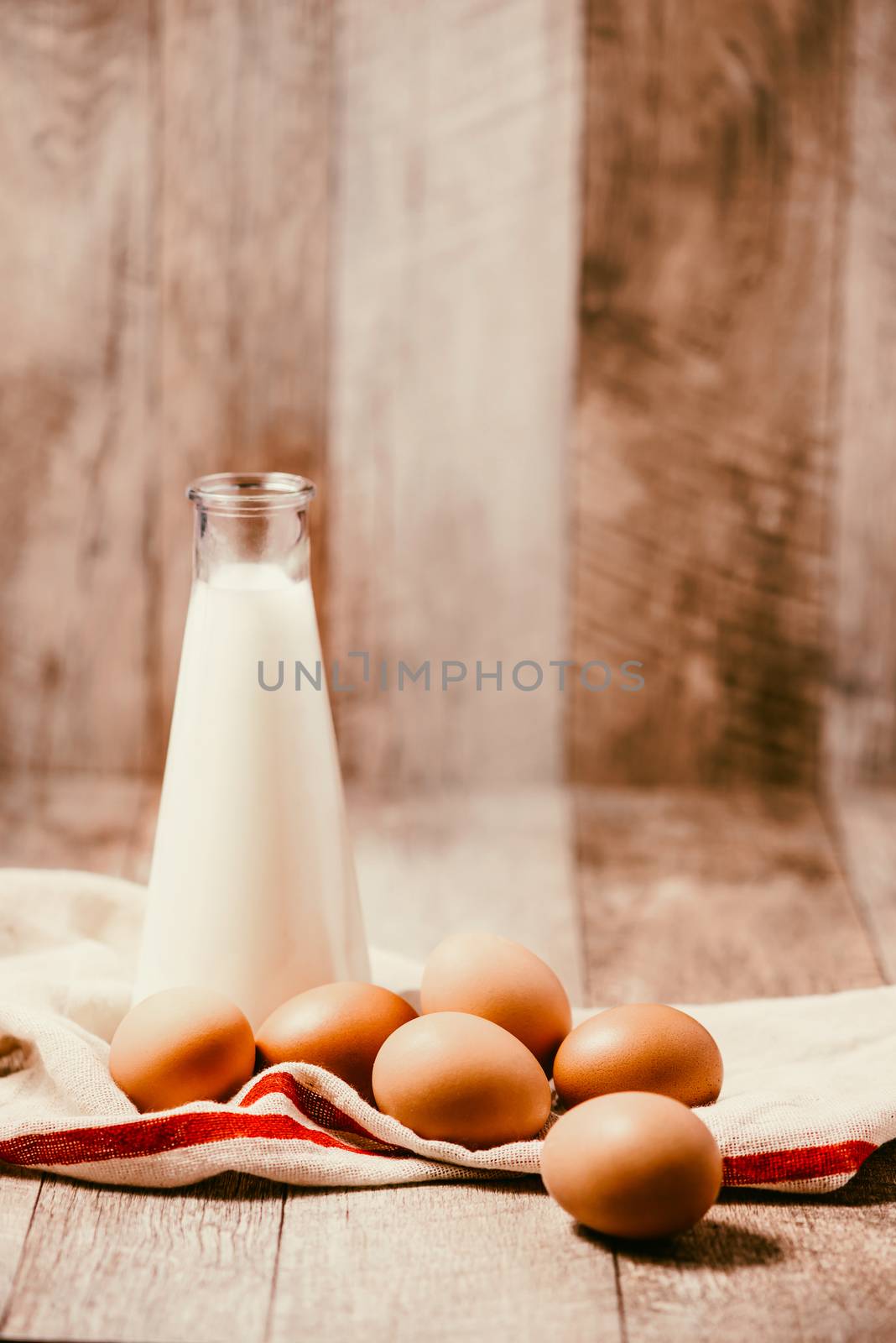 Eggs and milk on wooden background. Copy-space