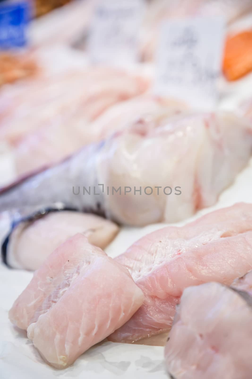 Fresh monkfish fillet on ice for sale at market
