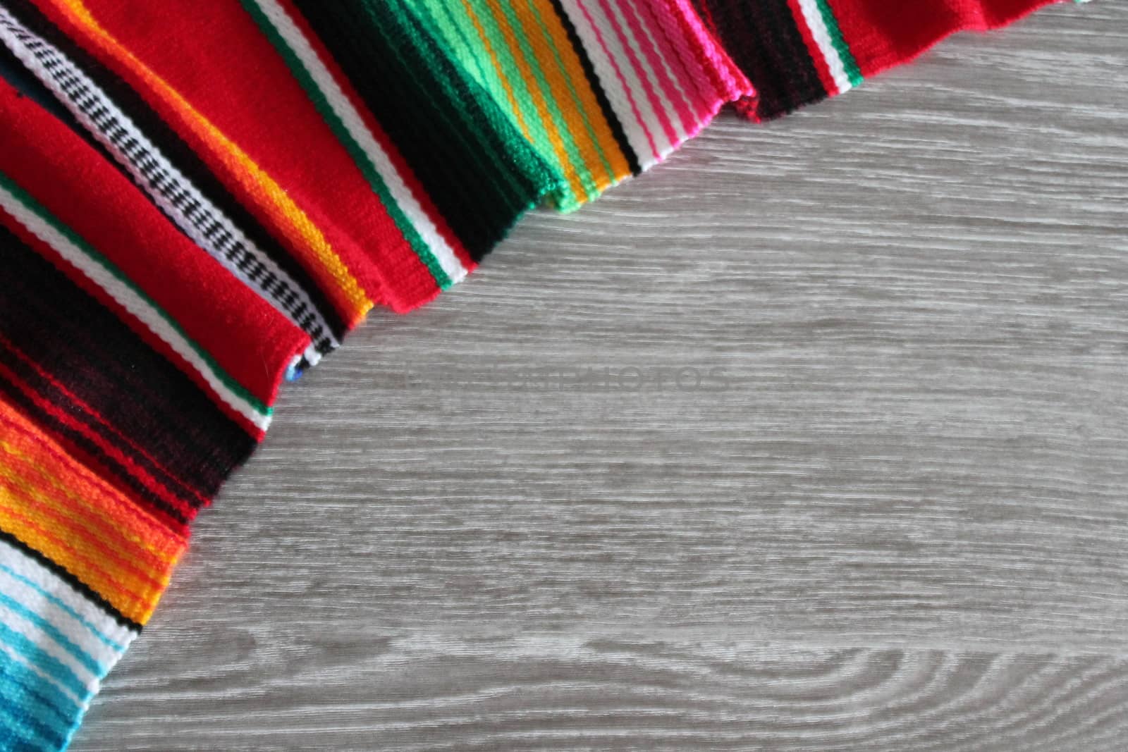 poncho serape background Mexican cinco de mayo fiesta wooden copy space by cheekylorns