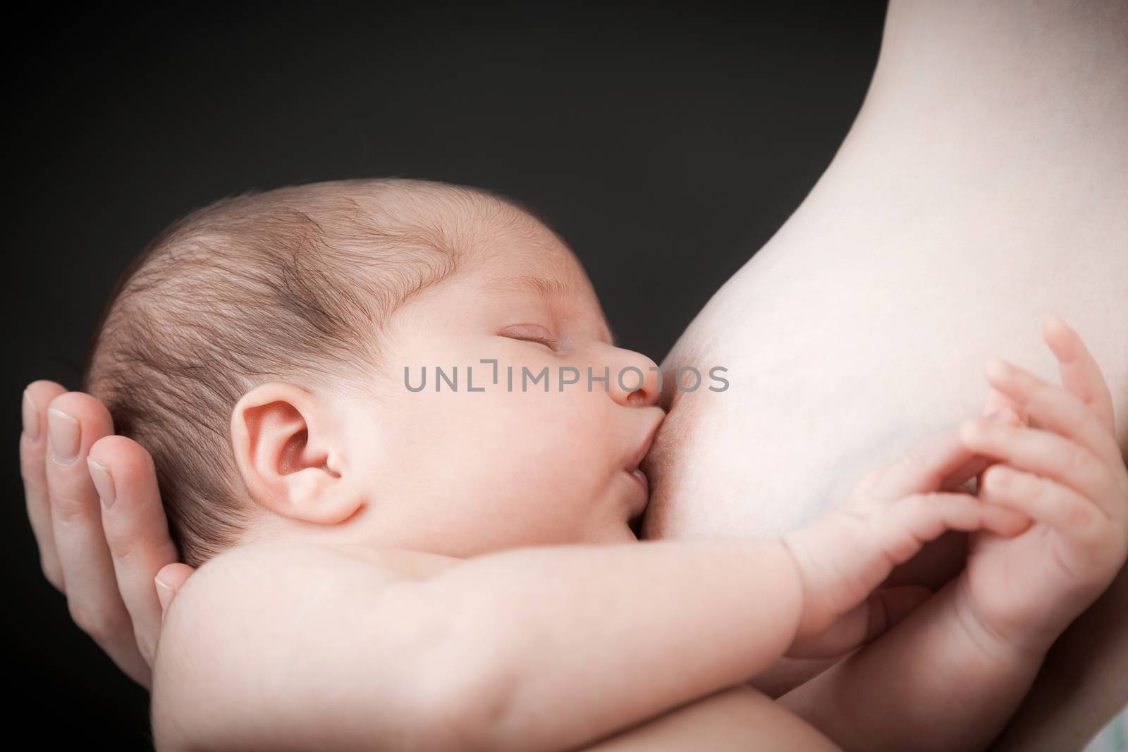 the newborn child eats milk of a breast of mother